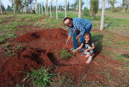 Dr Waweru planting a seedling 