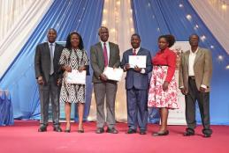 Prof Ojuka awarding Mr Simiyu and Mr Barake for excellent performance in their work